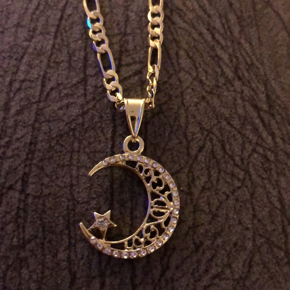 laminated gold chain with moon and star pendant the star.  it is.  small